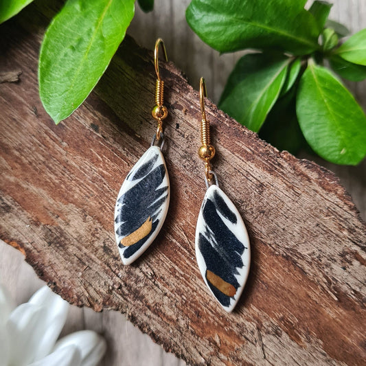 Handmade ceramic white earrings with a dark brush effect and 24c gold