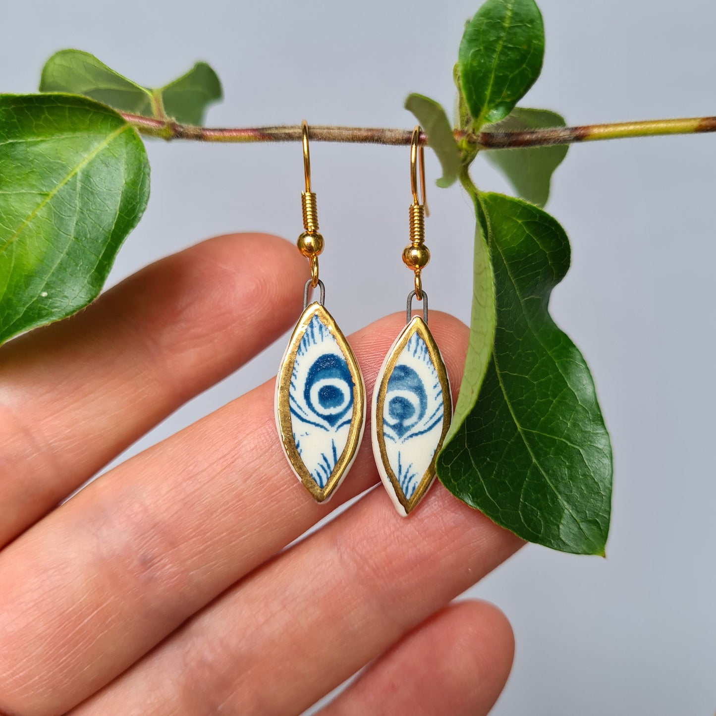 Handmade ceramic earrings with 24c gold (white and blue ceramic peacock)