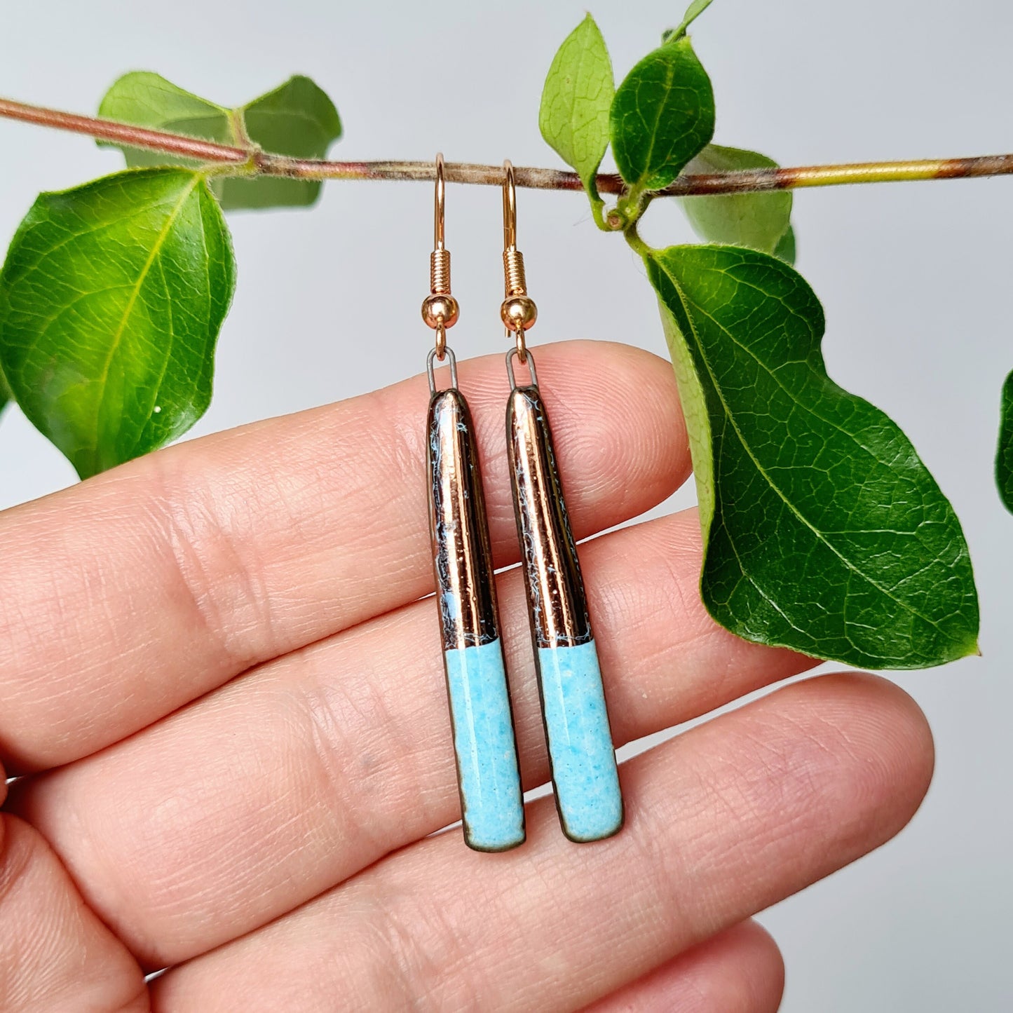 Handmade ceramic earrings with copper luster on black clay